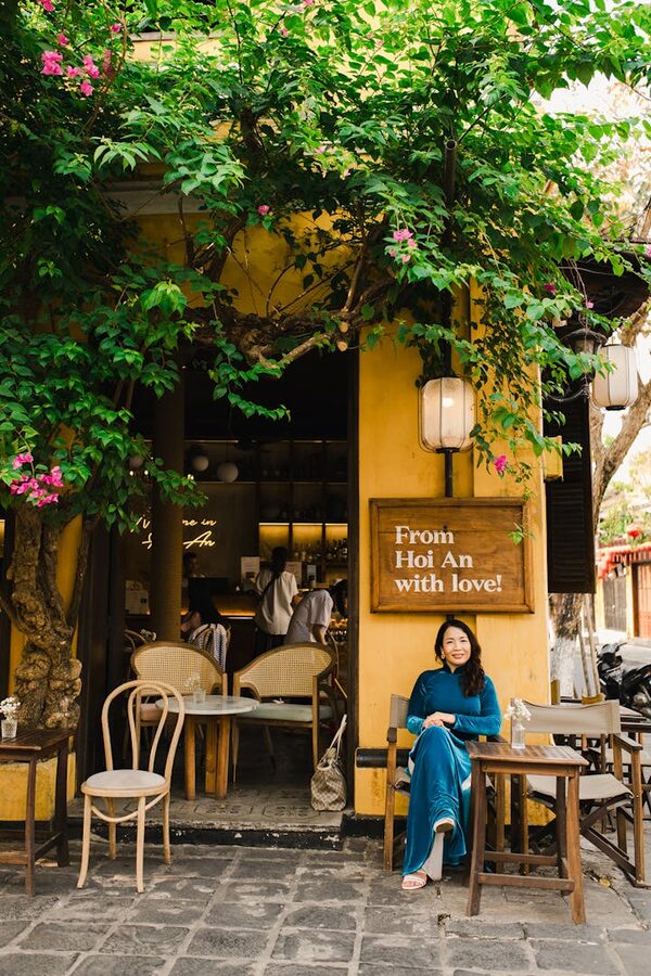 A cafe on a quiet Hoi An side street with small plastic stools and hanging lanterns