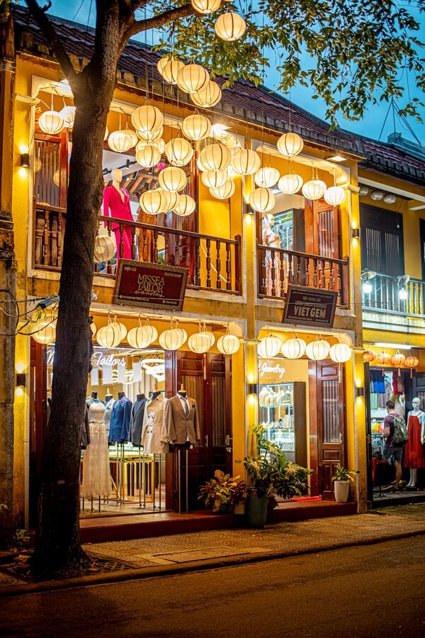Evening view of a boutique in Hoi An adorned with lanterns