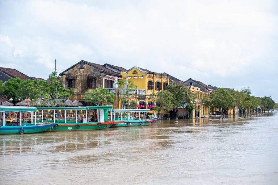 Serene riverside view of Hoi An historic architecture with colorful lanterns