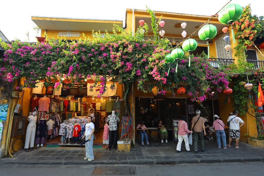 Charming street shop in Hoi An with colorful lanterns and bougainvillea