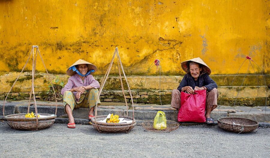 Elderly street vendors in the old town of Hoi An Vietnam