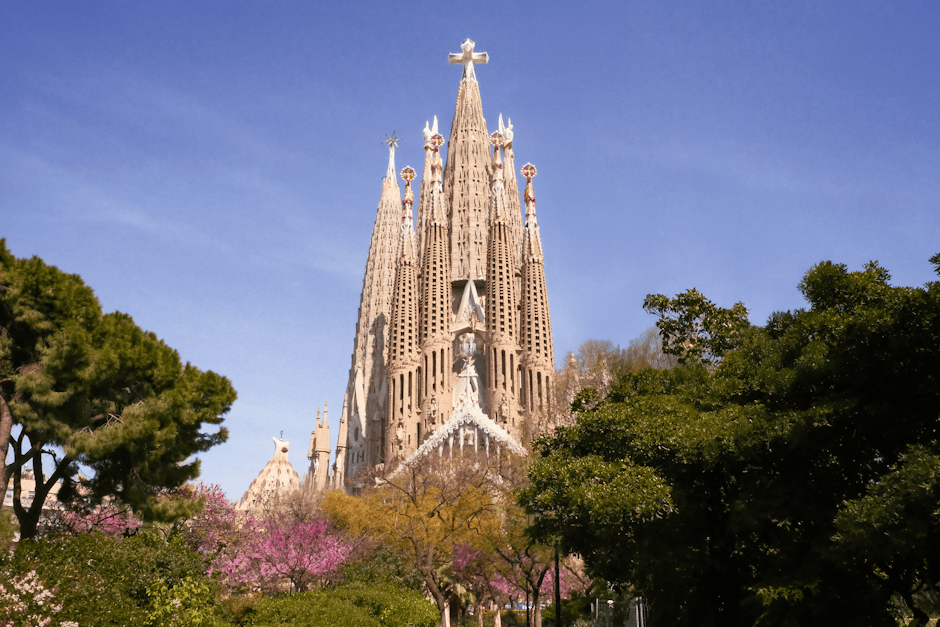 Sagrada Familia exterior with trees on a clear day