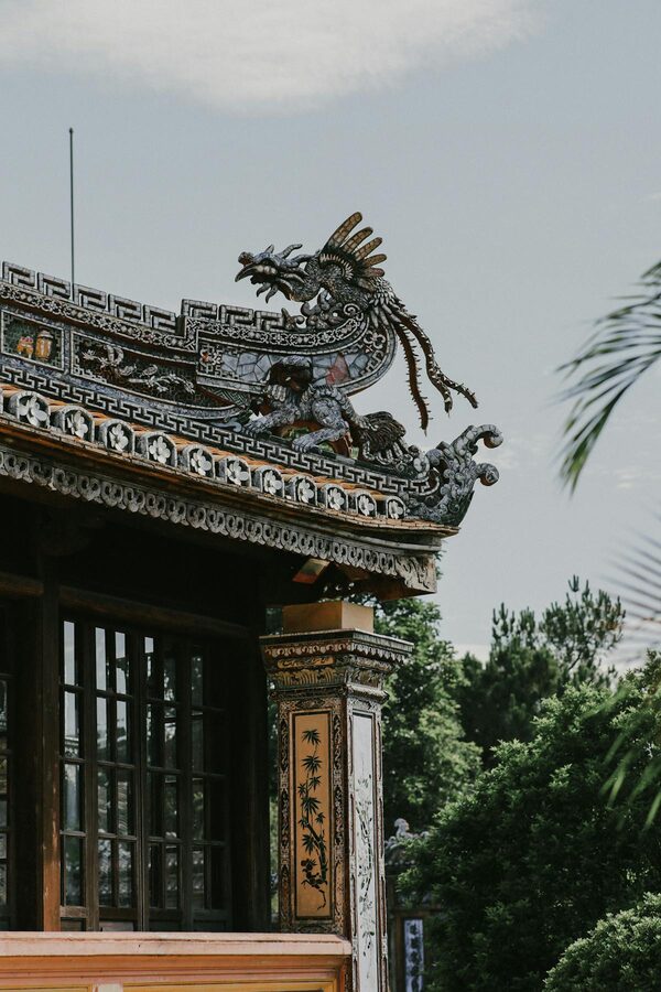 Artistic dragon sculpture on a traditional temple rooftop in Hue Vietnam
