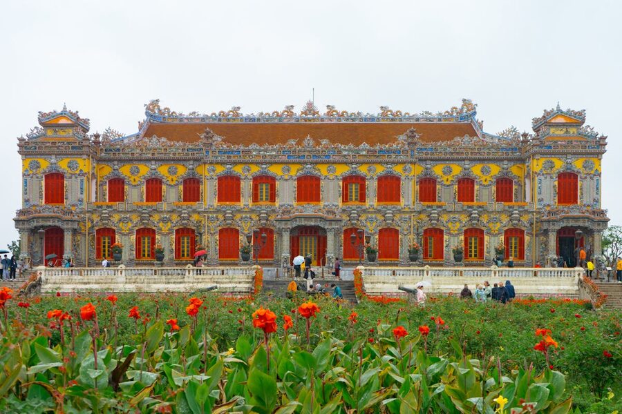Entrance to the Hue Imperial City with colorful flowers in the foreground