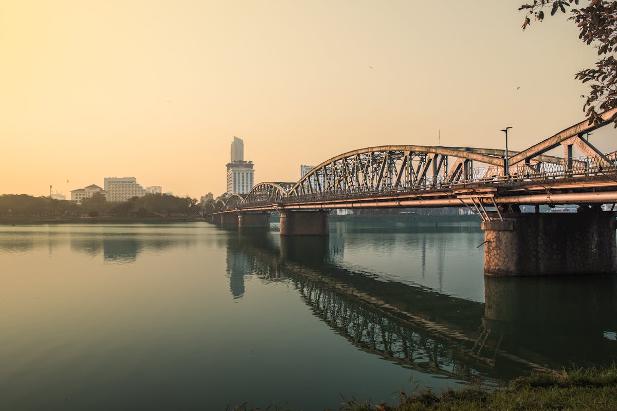 Truong Tien Bridge reflected in the Perfume River at sunset in Hue Vietnam