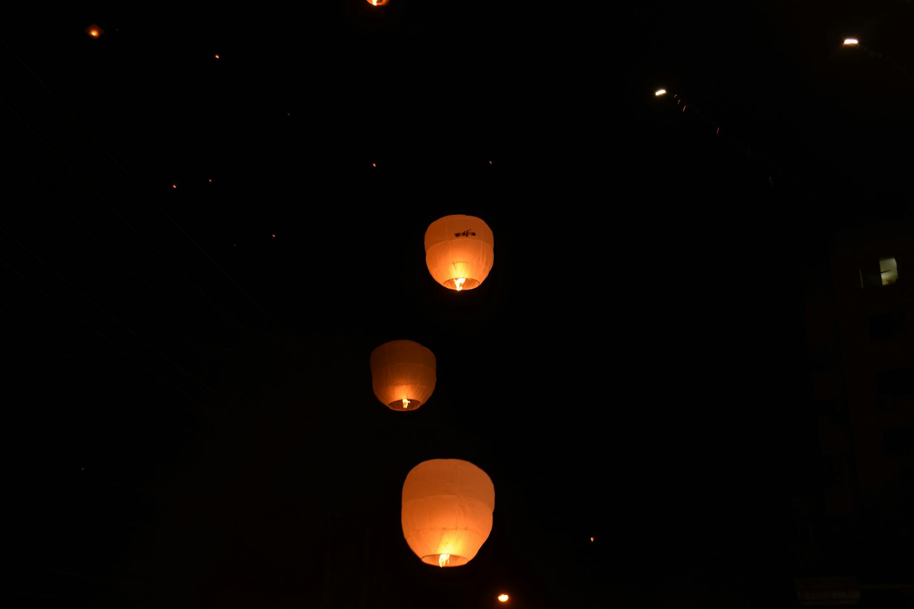 Sky lanterns glowing against night sky