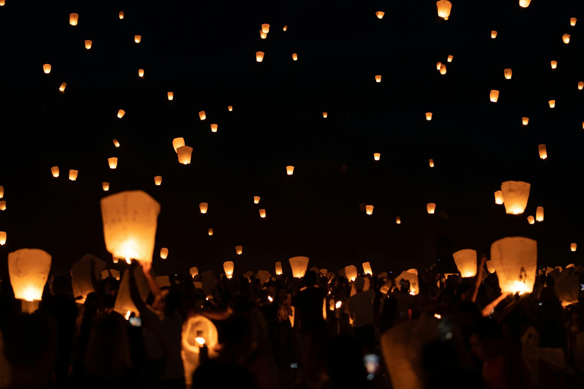 Sky lanterns rising into the night sky
