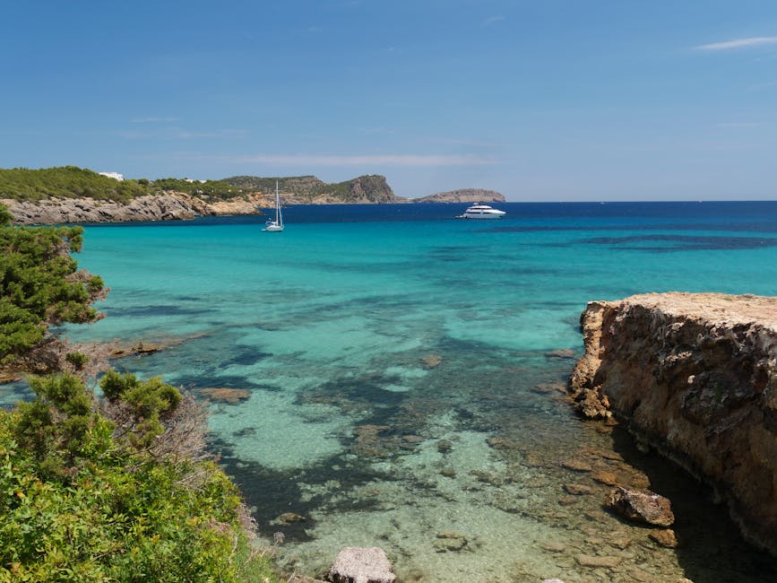 Turquoise water and rocky coastline at a cala on the Ibiza coast