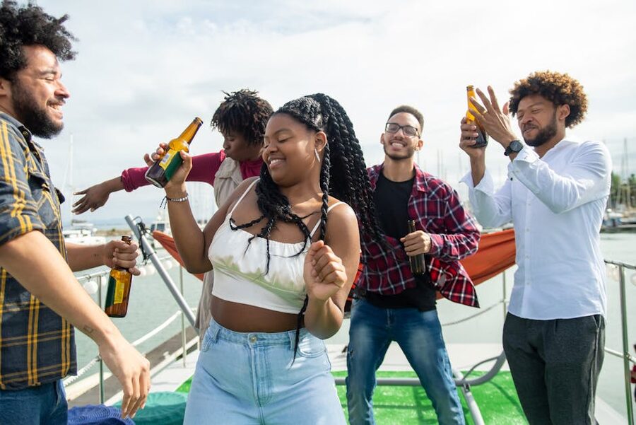 Group of friends with drinks on the deck of a boat