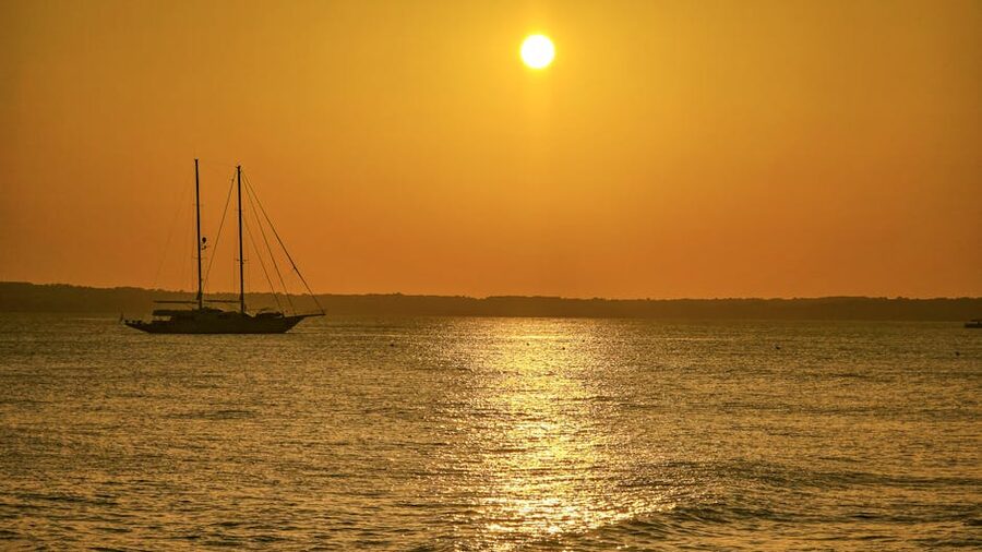 Sailboat at sunset in Ibiza Mediterranean