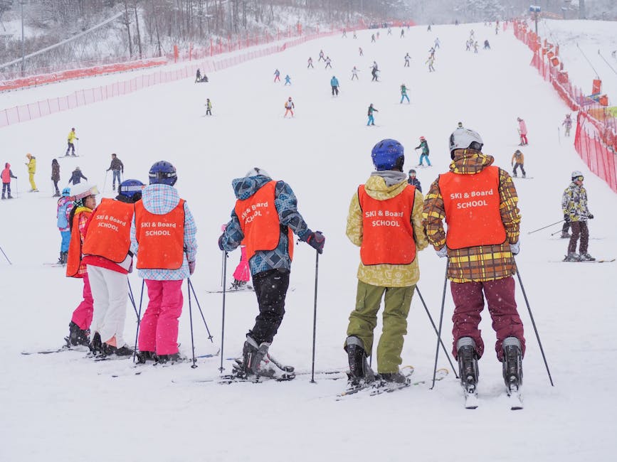 Beginner skiers taking a group lesson on a snowy slope in Pyeongchang