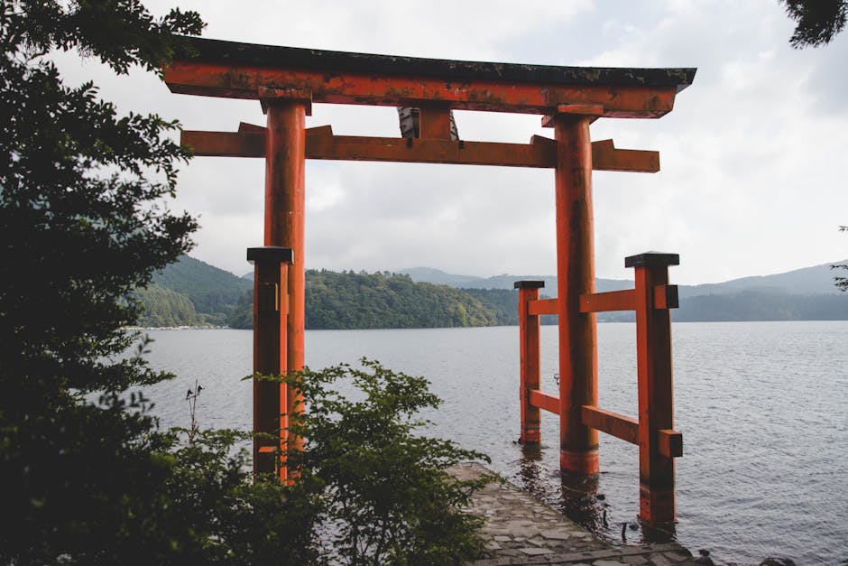 Red torii gate of Hakone Shrine standing in the waters of Lake Ashi