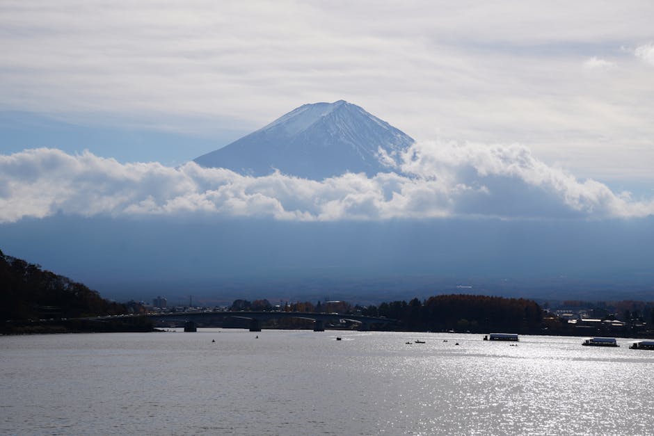 Mount Fuji towering over Lake Kawaguchi surrounded by autumn foliage