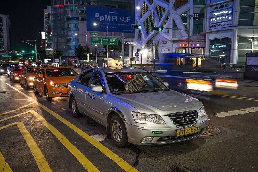 Taxi rank with orange taxis in Seoul