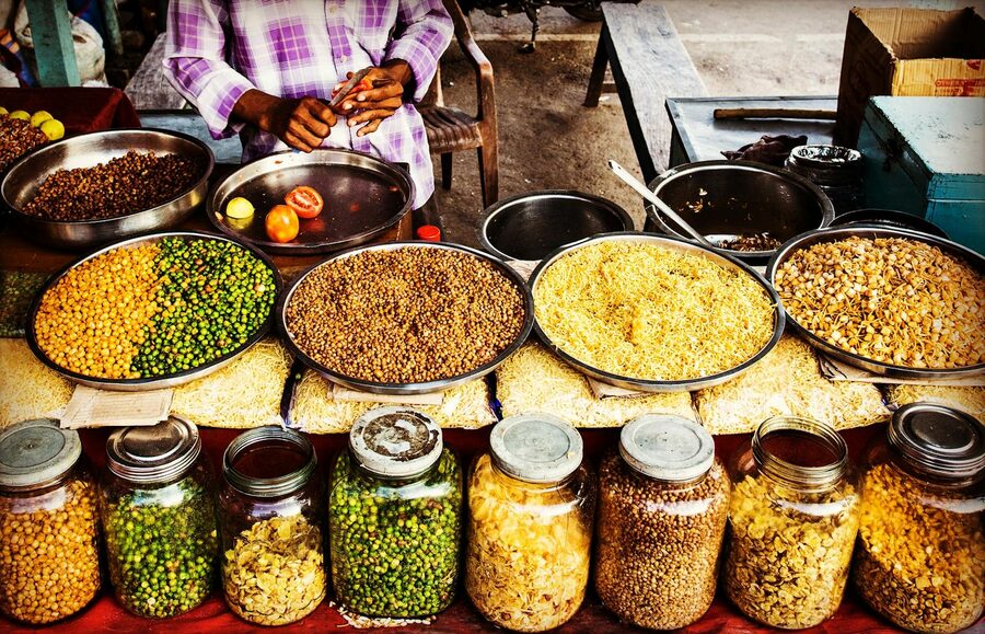 Colorful display of spices and legumes in a traditional Indian market