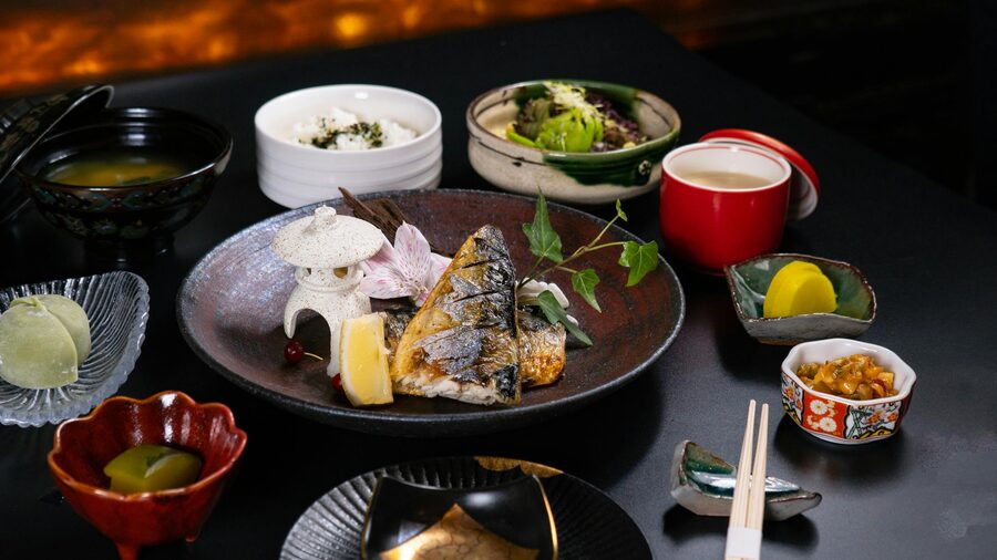 Japanese grilled fish and side dishes in a traditional dining setting