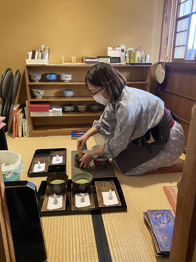 Host preparing utensils for Japanese tea ceremony