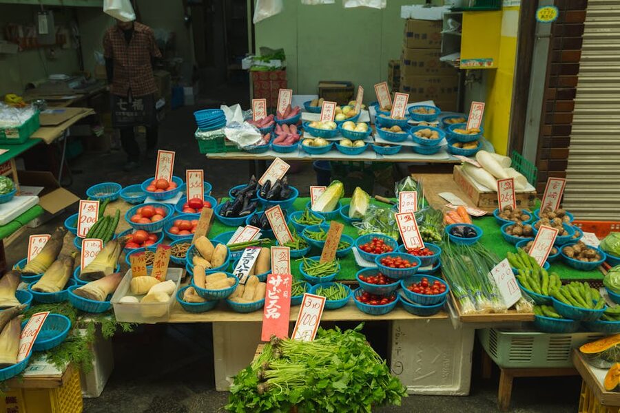 Japanese trader selling fresh vegetables at market