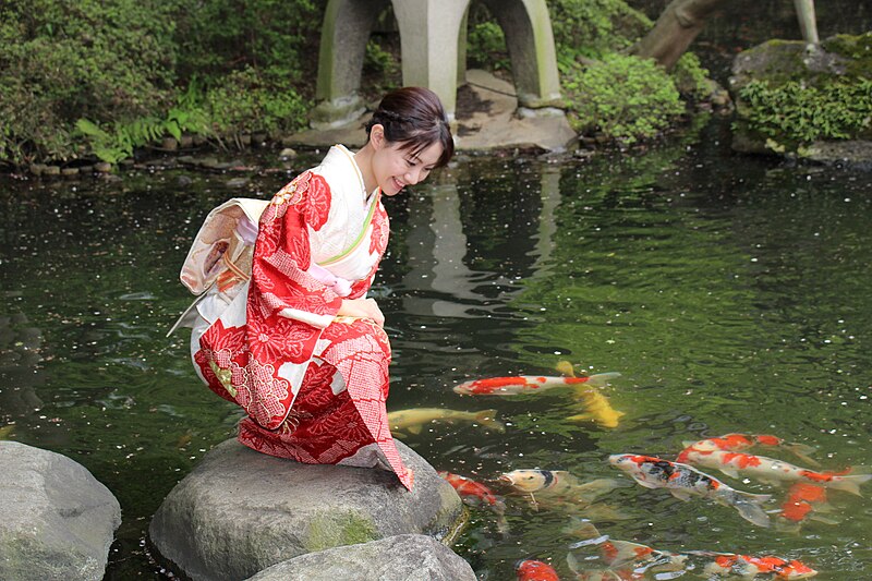 Japanese woman wearing kimono in traditional garden