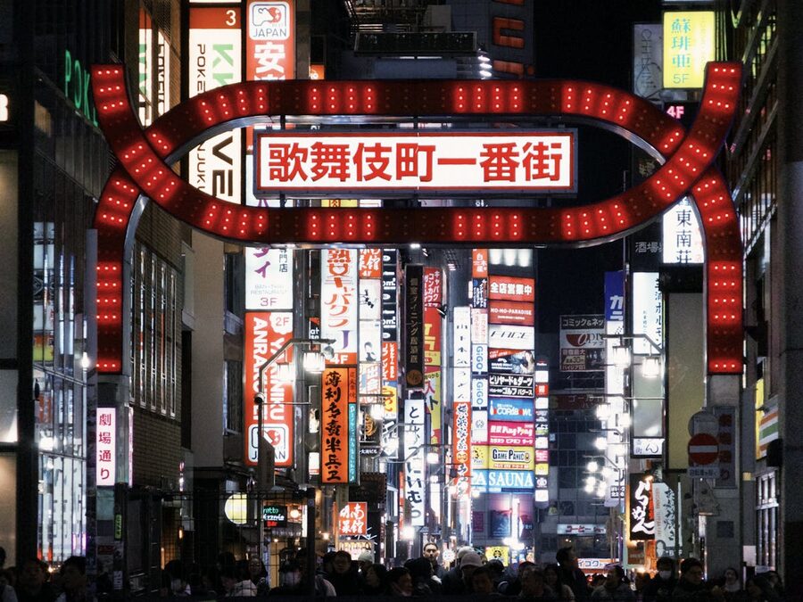 Bright colorful neon signs illuminating Kabukicho street in Tokyo at night
