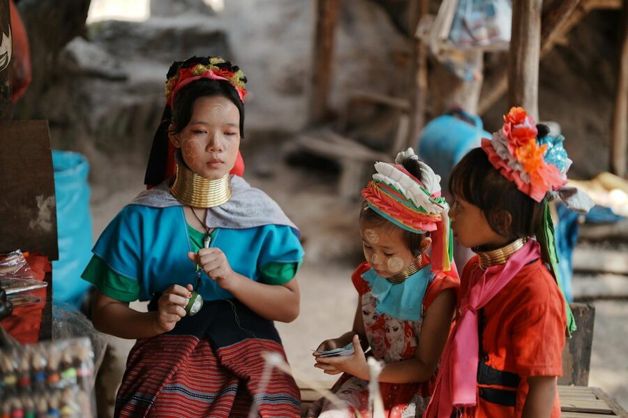 Young Karen hill tribe women and children wearing traditional attire in Thailand