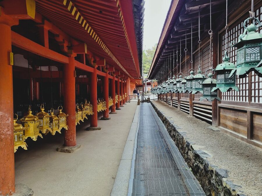 Historic Japanese shrine with traditional lanterns and red pillars