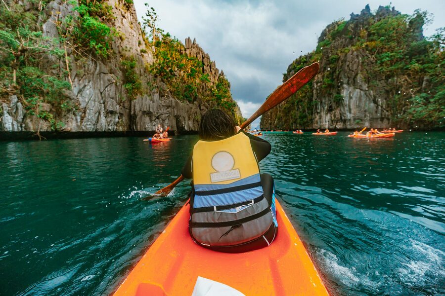 Kayakers exploring the limestone walls of Big Lagoon El Nido