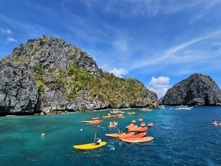 Kayakers exploring limestone cliffs in Palawan