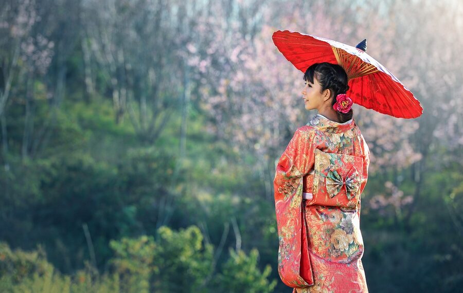 Woman in kimono with parasol at Japanese ceremony