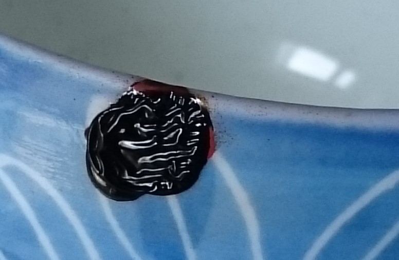 A failed kintsugi attempt where the lacquer was applied too thickly and wrinkled on the surface