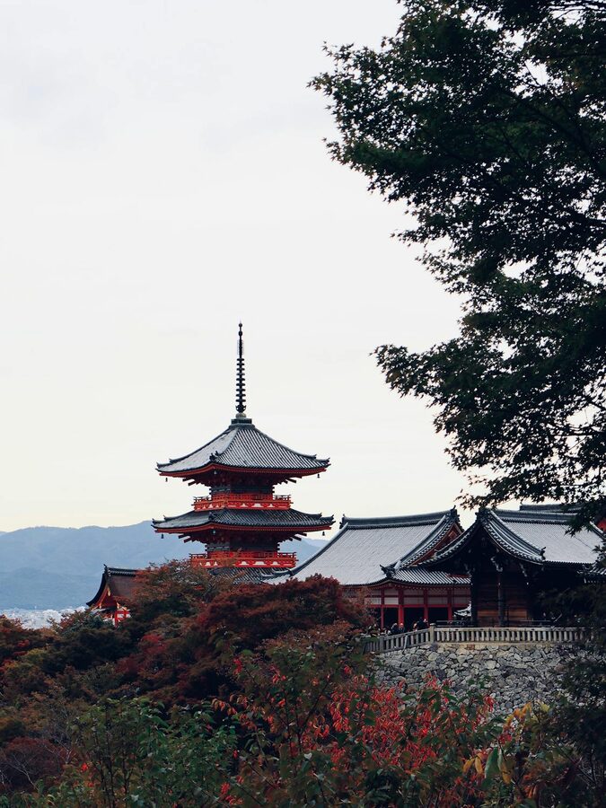 Kiyomizu-dera Temple wooden platform with lush green foliage surrounding it
