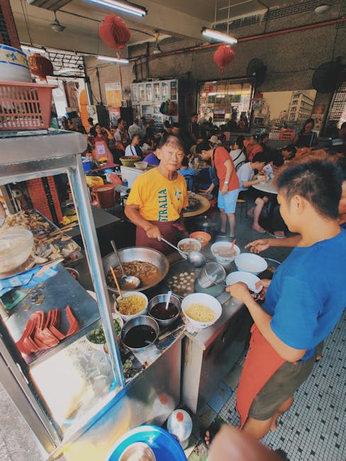 lively scene of locals enjoying traditional street food at a Kuala Lumpur market
