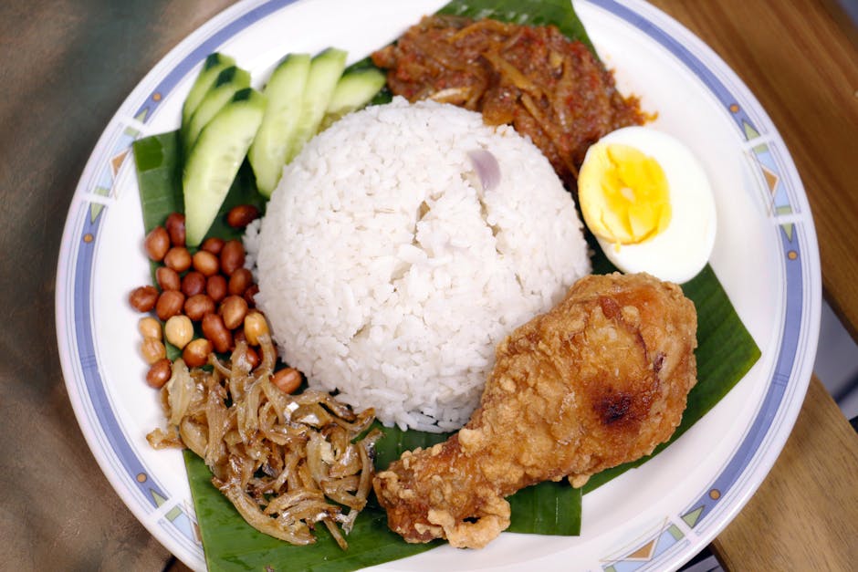 A lively plate of traditional Nasi Lemak with rice fried chicken and sambal