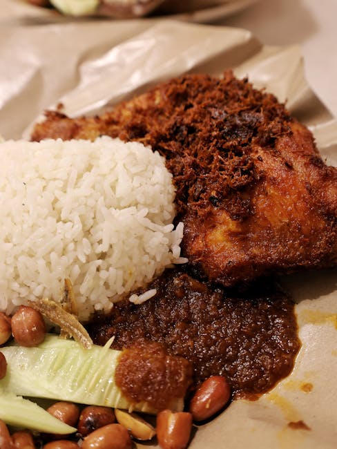 Close-up of traditional Nasi Lemak with fried chicken served on a plate in Kuala Lumpur