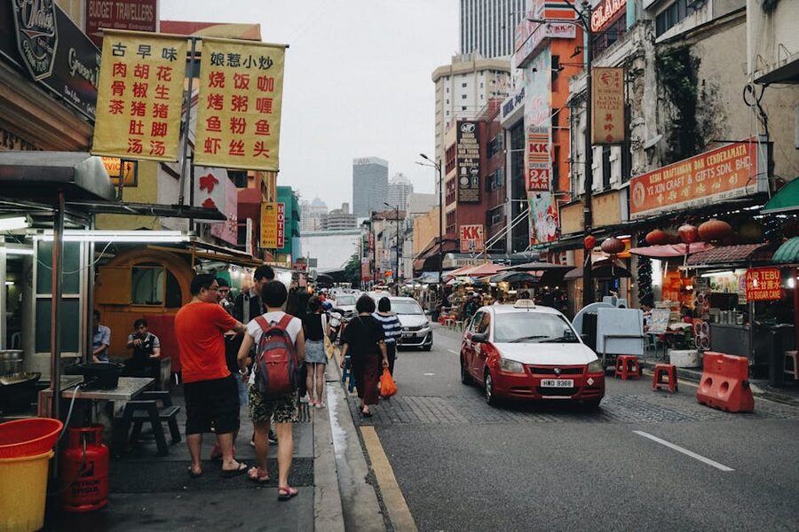 lively street scene in Kuala Lumpur's Chinatown with red lanterns and food stalls