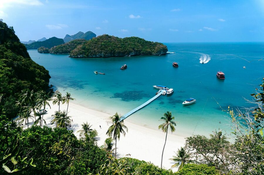 Aerial view of tropical Thai islands with turquoise water and boats