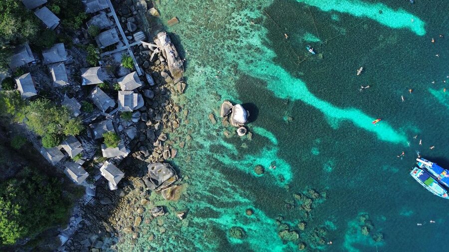 Aerial view of Koh Tao coastline with clear turquoise waters in Thailand