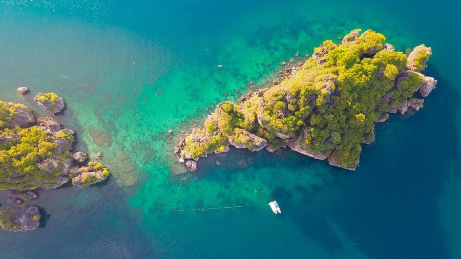 Aerial view of Thai island with lush greenery and turquoise waters