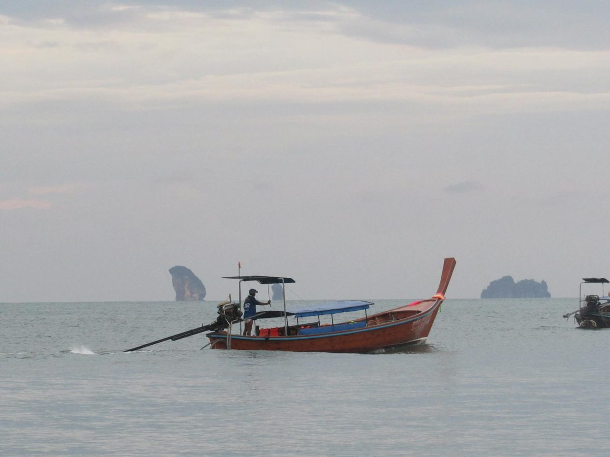 Traditional Thai longtail boat on calm turquoise water