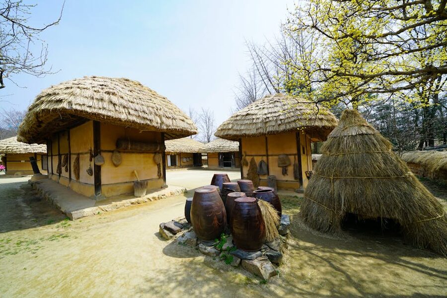 Thatched Korean village huts with food stalls in spring