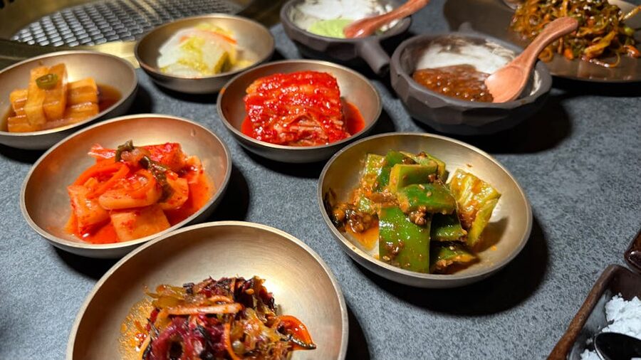 Assorted Korean banchan side dishes including several kimchi varieties