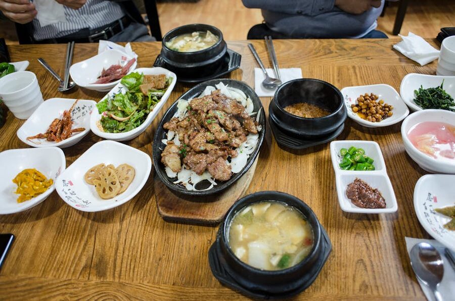 Overhead view of Korean dining spread with multiple dishes and kimchi