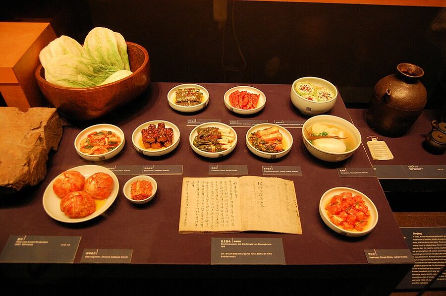 A spread of different kimchi varieties on a wooden tray in Seoul