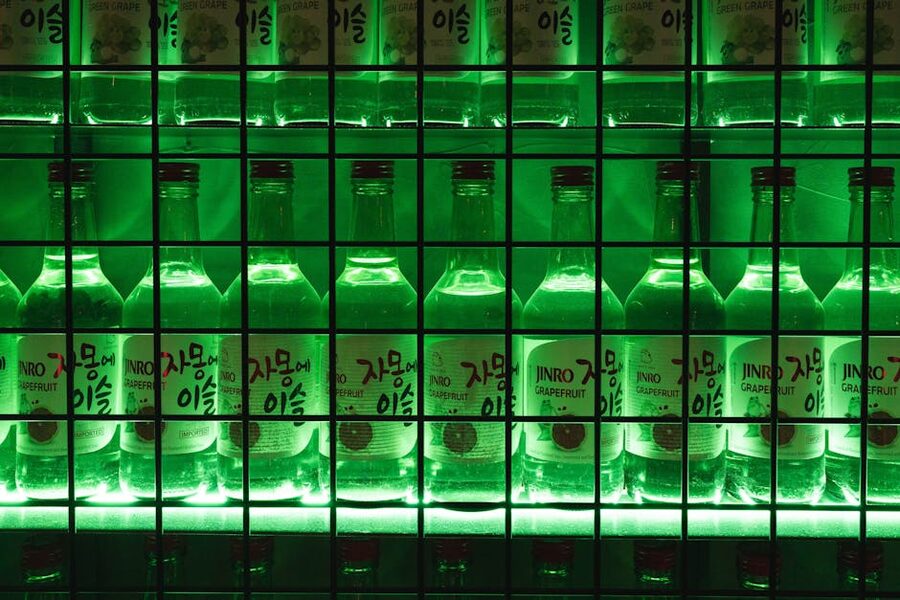 Illuminated Jinro grapefruit soju bottles on a shelf