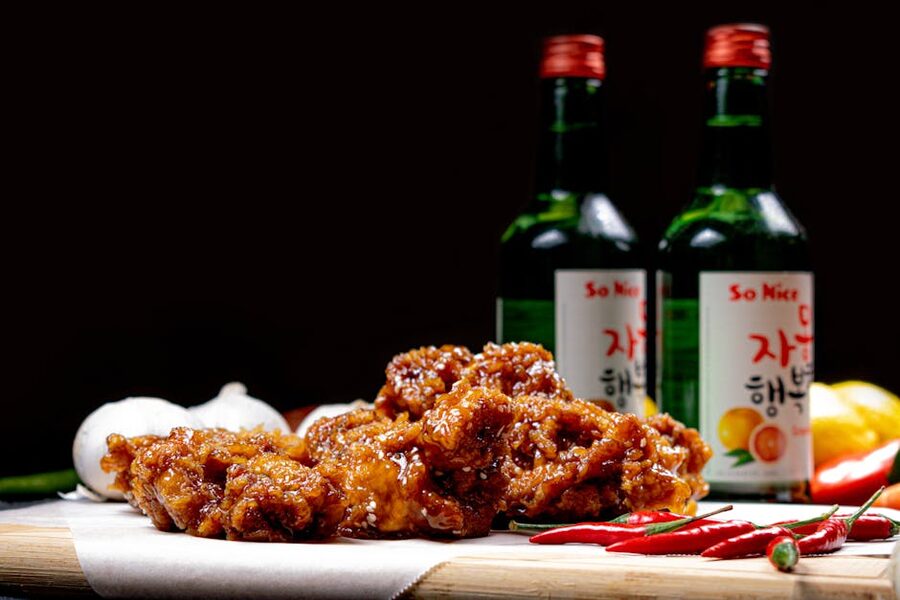 Korean fried chicken with soju bottles and chili