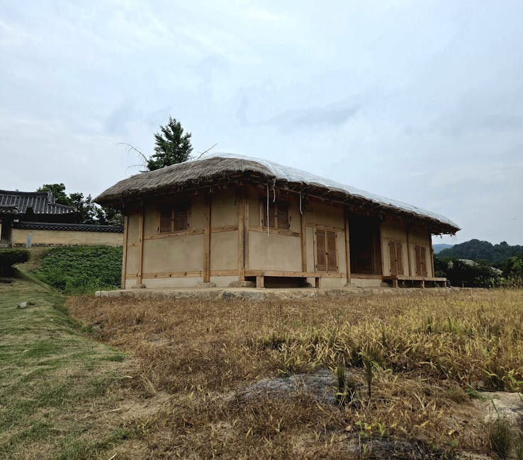 Wooden Korean house with traditional roof and deck