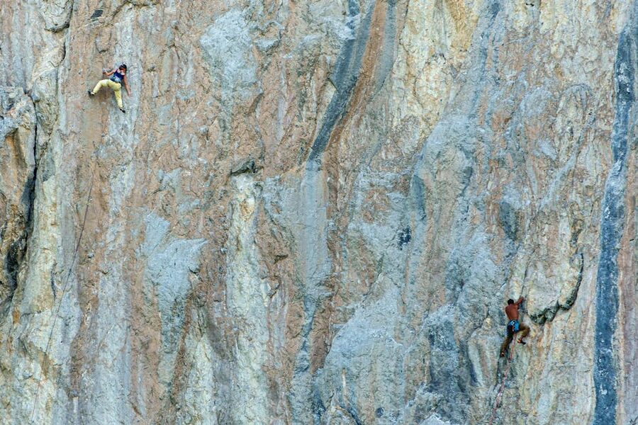 Rock climbers on Kalymnos limestone cliffs sport climbing