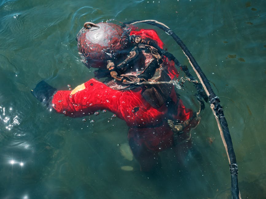 Vintage diver in red surface-supplied diving suit