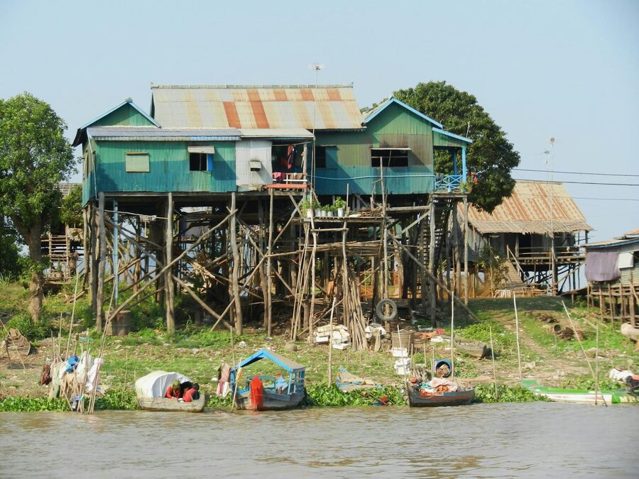 Traditional stilt houses along a riverbank in rural Cambodia
