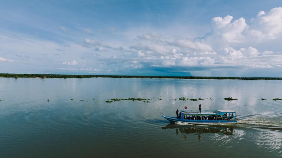 Small boat on the vast open water of Tonle Sap Lake Cambodia